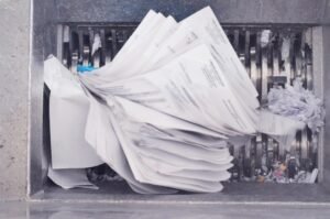 Employee managing confidential business documents.