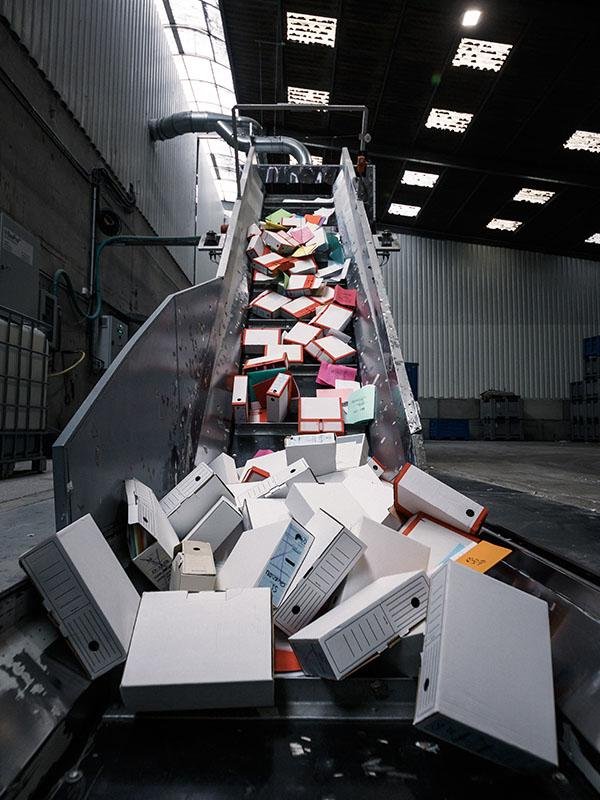 Bulk paper shredding of confidential business documents using an industrial shredder.