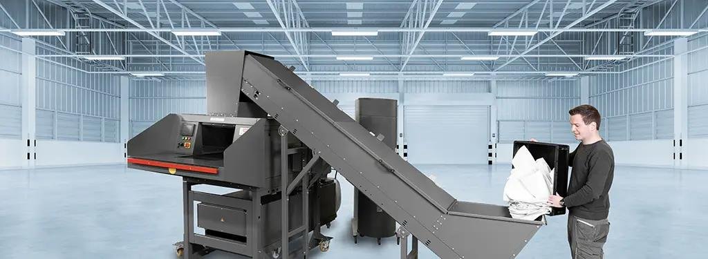 Industrial bulk paper shredding process for securely destroying confidential business documents.